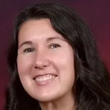 Clerissa Lewis, Bestie Squad member, smiling in a black top